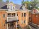 Stunning two-story brick home with dual balconies, awnings, and charming architectural details at 2124 E 17Th Ave # 4, Denver, CO 80206