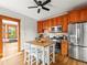 Eat-in kitchen features stainless steel appliances, a center island and custom cabinetry at 2124 E 17Th Ave # 4, Denver, CO 80206