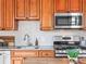 This kitchen boasts stainless steel appliances and warm wood cabinetry at 2124 E 17Th Ave # 4, Denver, CO 80206