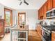 Well-lit kitchen with stainless appliances, custom cabinets, and hardwood floors at 2124 E 17Th Ave # 4, Denver, CO 80206