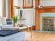 Cozy living room showcasing a unique fireplace, hardwood floors, and stylish decor at 2124 E 17Th Ave # 4, Denver, CO 80206