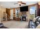 Cozy living room with a fireplace, comfortable leather seating, and convenient access to the entryway and stairs at 12744 Leyden St # F, Thornton, CO 80602