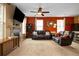 Inviting living room with plush leather seating, a fireplace, and large windows for natural light at 12744 Leyden St # F, Thornton, CO 80602