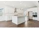 Modern kitchen featuring white cabinets, an island with seating, and stainless-steel appliances at 13750 Emerald Lake St, Parker, CO 80138
