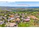 Aerial view of suburban neighborhood, showcasing downtown Denver in the distance on a bright day at 6194 Falcon Ridge Way, Morrison, CO 80465