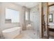 Luxurious bathroom with a standalone tub, walk-in shower, and contemporary fixtures at 6194 Falcon Ridge Way, Morrison, CO 80465