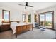 Bright bedroom with large windows, balcony, and hardwood floors offers plenty of natural light at 6194 Falcon Ridge Way, Morrison, CO 80465