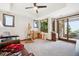 A large bonus room with a large window, glass doors, and a wooden desk at 6194 Falcon Ridge Way, Morrison, CO 80465