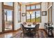 Inviting dining area with large windows offering picturesque mountain views, enhancing the dining experience at 6194 Falcon Ridge Way, Morrison, CO 80465