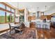 Bright dining area adjacent to the kitchen, featuring large windows with scenic views and stylish furnishings at 6194 Falcon Ridge Way, Morrison, CO 80465
