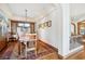 Elegant dining room with a wooden table, shuttered window, and classic details at 6194 Falcon Ridge Way, Morrison, CO 80465
