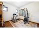 Bright exercise room with a treadmill and a multi-station weight machine on a floral carpet at 6194 Falcon Ridge Way, Morrison, CO 80465