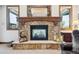 Stone fireplace with a wooden mantel, decorative statues, and a deer figurine at 6194 Falcon Ridge Way, Morrison, CO 80465