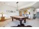 Game room with a pool table, stone archway leading to the bar, and modern lighting at 6194 Falcon Ridge Way, Morrison, CO 80465