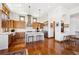 Open kitchen with custom wood cabinets, a large island, and hardwood floors, perfect for entertaining at 6194 Falcon Ridge Way, Morrison, CO 80465