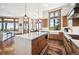Gourmet kitchen with custom cabinets, a marble island, and high-end appliances, all overlooking the scenic landscape at 6194 Falcon Ridge Way, Morrison, CO 80465