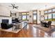 Spacious living room and dining area with a fireplace, large windows, and hardwood flooring throughout at 6194 Falcon Ridge Way, Morrison, CO 80465