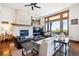 Bright living room with stone fireplace, modern furniture, and large windows showcasing an expansive view at 6194 Falcon Ridge Way, Morrison, CO 80465