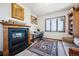 Comfortable home office space with a fireplace, built-in shelving, and a scenic view at 6194 Falcon Ridge Way, Morrison, CO 80465