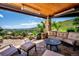 Cozy covered outdoor seating area with scenic views of the surrounding landscape at 6194 Falcon Ridge Way, Morrison, CO 80465