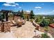 Beautiful stone patio with a pergola and outdoor seating, perfect for enjoying the scenic views at 6194 Falcon Ridge Way, Morrison, CO 80465