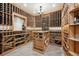 A stunning wine cellar featuring a table with wooden wine racks and plenty of storage space at 6194 Falcon Ridge Way, Morrison, CO 80465