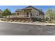 Charming home featuring a stone-accented entryway, well-maintained landscaping, and a welcoming facade on a sunny day at 6655 S Shawnee St, Aurora, CO 80016
