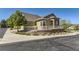 Beautiful home showcases manicured landscaping, stylish stone accents, a covered porch, and a two car garage at 6655 S Shawnee St, Aurora, CO 80016