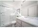 Bathroom featuring large walk-in shower with glass door and vanity with marble counters at 13588 E 103Rd Pl, Commerce City, CO 80022