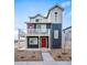 Stylish two-story home featuring a charming balcony, a red front door and low-maintenance landscaping at 13588 E 103Rd Pl, Commerce City, CO 80022