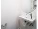 Modern powder room with a floating sink, brushed nickel fixtures, and clean white walls at 13588 E 103Rd Pl, Commerce City, CO 80022