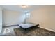 Finished basement bedroom with grey carpet and a platform bed frame at 11058 Grange Creek Dr, Thornton, CO 80233