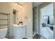 Well-lit bathroom featuring a vanity and walk-in shower with stone-style flooring at 11058 Grange Creek Dr, Thornton, CO 80233