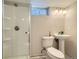 Bathroom featuring a glass shower, toilet, and pedestal sink, illuminated by overhead lights at 11058 Grange Creek Dr, Thornton, CO 80233