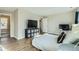 Spacious bedroom with wood floors and two TVs offering ample space for relaxation at 11058 Grange Creek Dr, Thornton, CO 80233