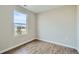 Well-lit bedroom with hardwood floors and large window at 11058 Grange Creek Dr, Thornton, CO 80233