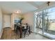 Cozy dining room area with wood floors, slider to outdoor patio, and seating for four at 11058 Grange Creek Dr, Thornton, CO 80233