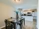 Kitchen and dining area with modern white cabinets and a granite countertop table at 11058 Grange Creek Dr, Thornton, CO 80233