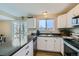 Galley kitchen with white shaker cabinets, granite countertops and stainless steel appliances at 11058 Grange Creek Dr, Thornton, CO 80233