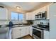 Modern kitchen features stainless steel appliances and white cabinetry at 11058 Grange Creek Dr, Thornton, CO 80233