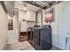 Laundry room area with washer, dryer, storage cabinets, and decorative rug at 11058 Grange Creek Dr, Thornton, CO 80233