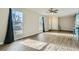 Living room with hardwood floors, large windows, and a view of the front yard at 11058 Grange Creek Dr, Thornton, CO 80233