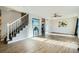 Bright living room with wood floors, staircase, and view into the kitchen with lots of natural light at 11058 Grange Creek Dr, Thornton, CO 80233