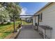 Backyard patio with covering, table, and partial view of fenced yard at 6751 Locust St, Commerce City, CO 80022