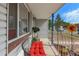 Inviting front porch with red bench, decorative sunflower, and 'Beware of Dog' sign at 6751 Locust St, Commerce City, CO 80022