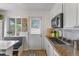 Updated kitchen boasts stainless steel appliances, granite countertops, and backyard access at 6751 Locust St, Commerce City, CO 80022