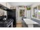 Bright eat-in kitchen features stainless steel appliances and breakfast nook near large window at 6751 Locust St, Commerce City, CO 80022