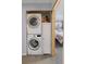 Convenient laundry area with stacked washer and dryer units, plus storage at 6751 Locust St, Commerce City, CO 80022