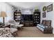 Comfortable living room featuring modern furniture, large TV, and shelving units at 6751 Locust St, Commerce City, CO 80022