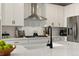 Close up of modern kitchen with white cabinets, stainless steel appliances, and a black faucet at 7875 Yampa River Ave, Littleton, CO 80125